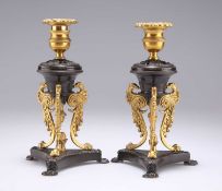 A PAIR OF REGENCY PATINATED AND GILT BRONZE DWARF CANDLESTICKS, IN THE MANNER OF CHENEY, LONDON