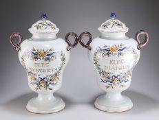 A PAIR OF 19TH CENTURY POLYCHROME DUTCH DELFT PHARMACY JARS AND COVERS