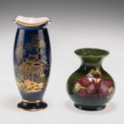 A WILLIAM MOORCOFT 'COLUMBINE' PATTERN POTTERY VASE, AND A WILTSHAW AND ROBINSON CARLTON WARE VASE