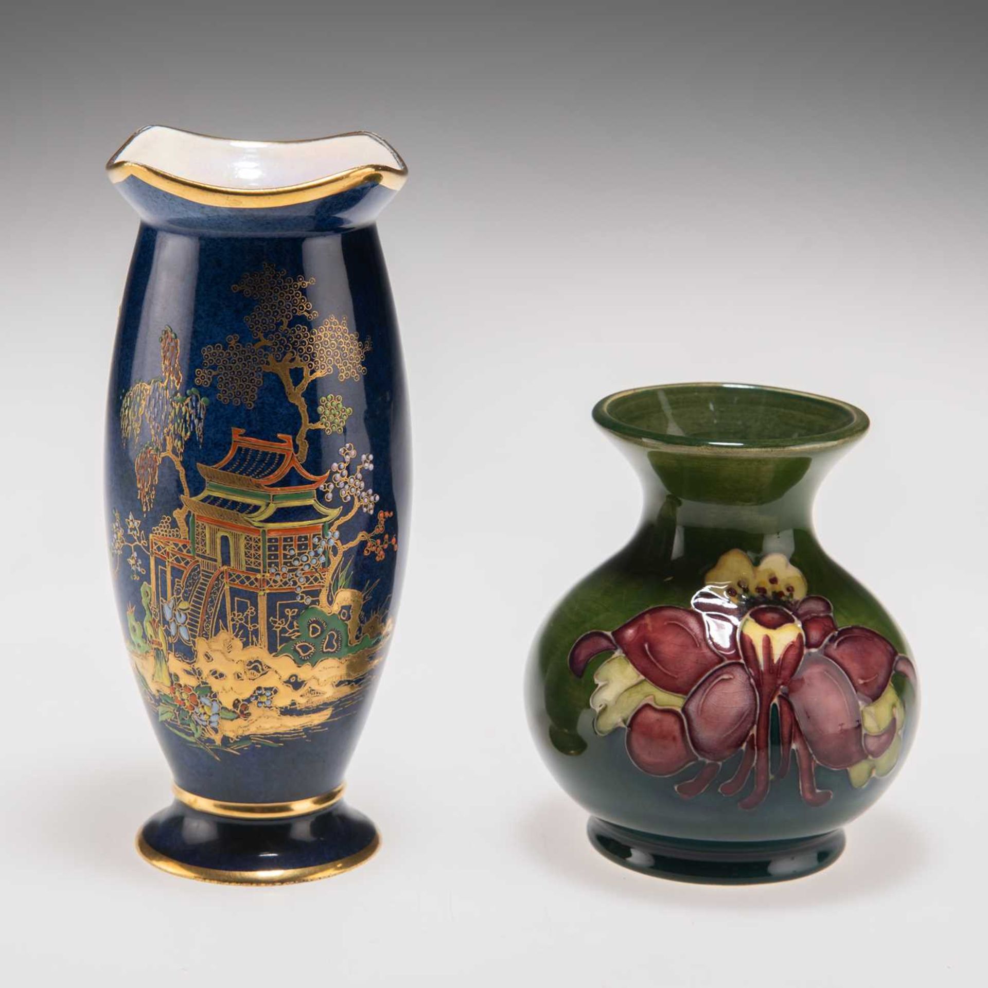 A WILLIAM MOORCOFT 'COLUMBINE' PATTERN POTTERY VASE, AND A WILTSHAW AND ROBINSON CARLTON WARE VASE