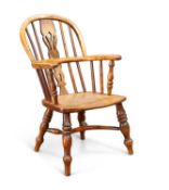 A GOOD 19TH CENTURY YEW WOOD CHILD'S WINDSOR ARMCHAIR