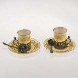A PAIR OF ROYAL WORCESTER SILVER-MOUNTED COFFEE CANS, WITH A PAIR OF SILVER SPOONS