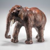 A 20TH CENTURY LIBERTY STYLE LEATHER CLAD MODEL OF AN INDIAN ELEPHANT