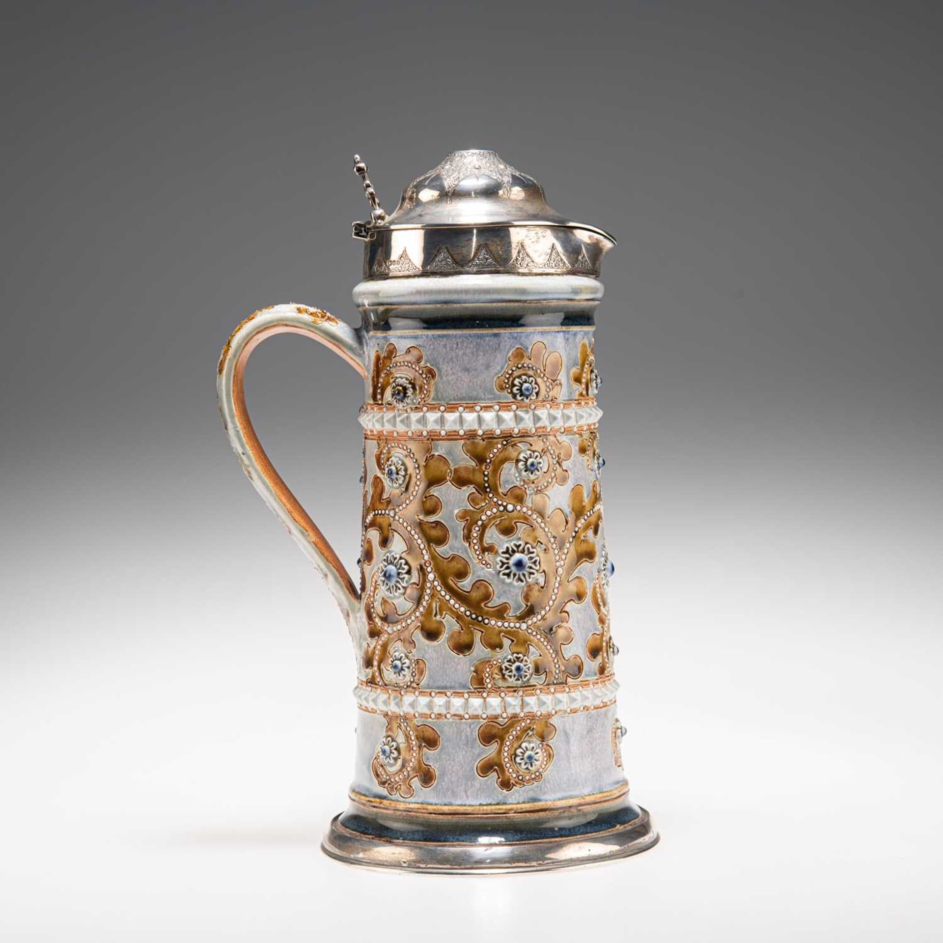 GEORGE TINWORTH FOR DOULTON LAMBETH, A SILVER-MOUNTED STONEWARE LEMONADE JUG, CIRCA 1877