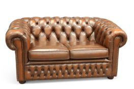 A BROWN LEATHER CHESTERFIELD TWO-SEATER SOFA