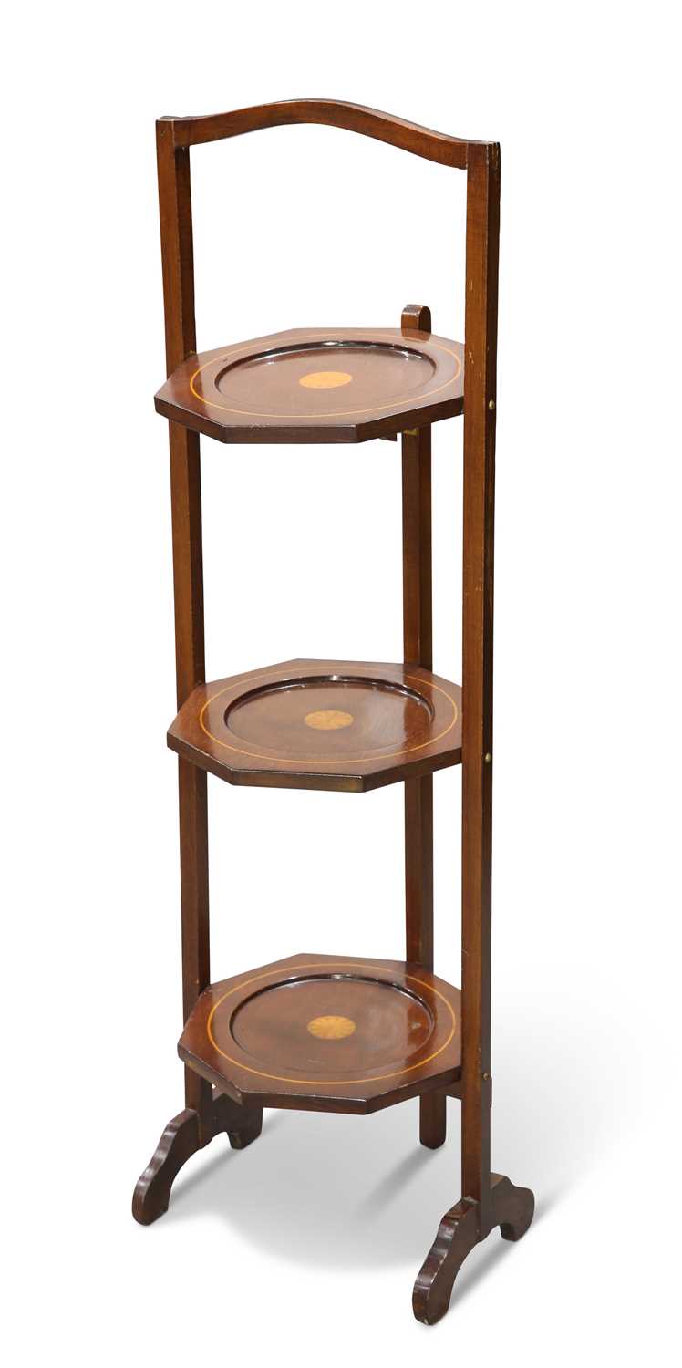 AN EDWARDIAN INLAID MAHOGANY FOLDING CAKESTAND