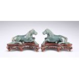 A PAIR OF CHINESE SPINACH JADE MODELS OF RECUMBENT HORSES