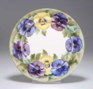 A WILLIAM MOORCROFT 'PANSY' PATTERN POTTERY SIDE PLATE