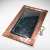 AN ARTS AND CRAFTS COPPER MIRROR