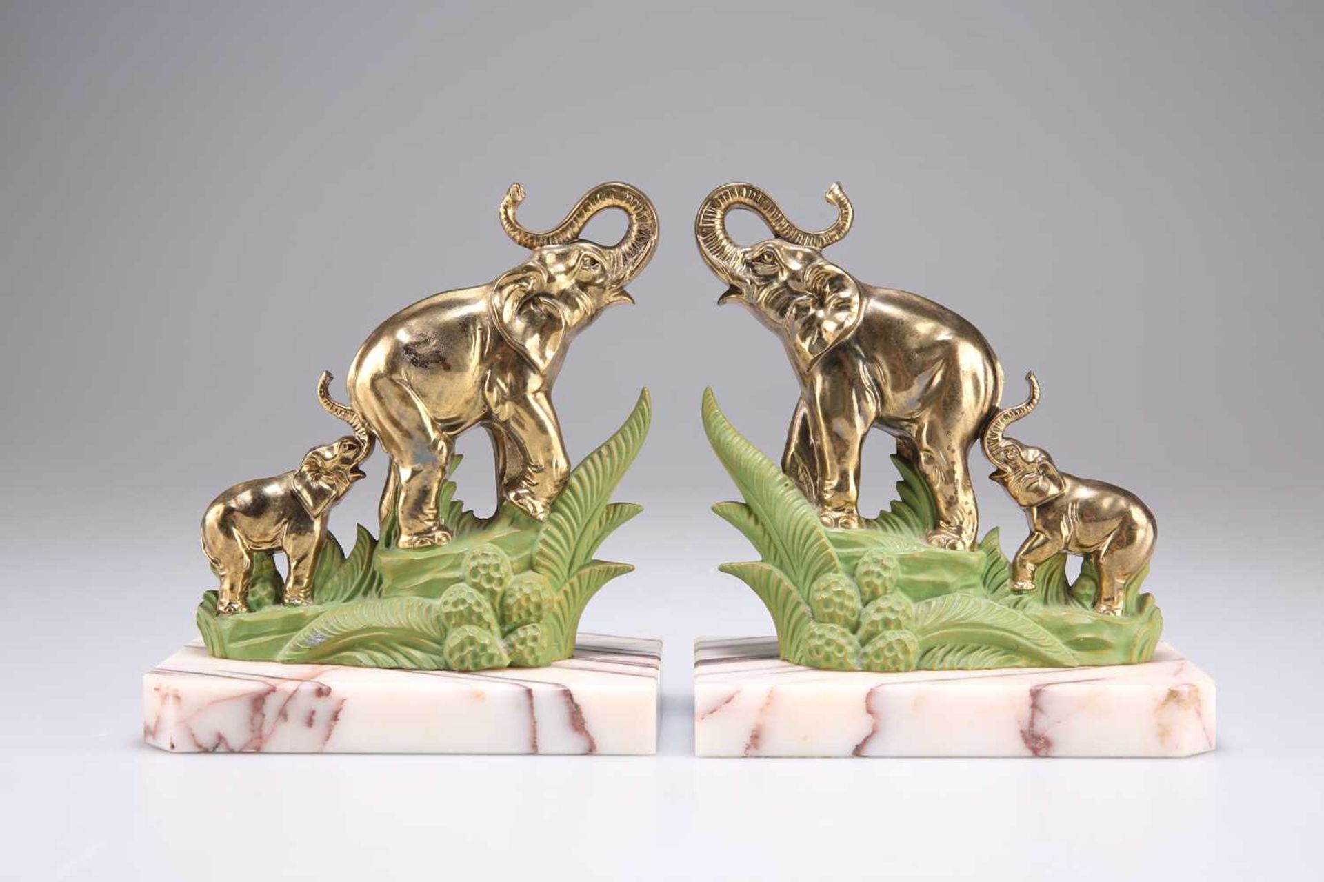 A PAIR OF ART DECO BRASS AND PAINTED 'ELEPHANT' BOOKENDS