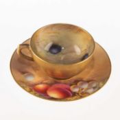 A ROYAL WORCESTER FRUIT PAINTED MINIATURE CUP AND SAUCER