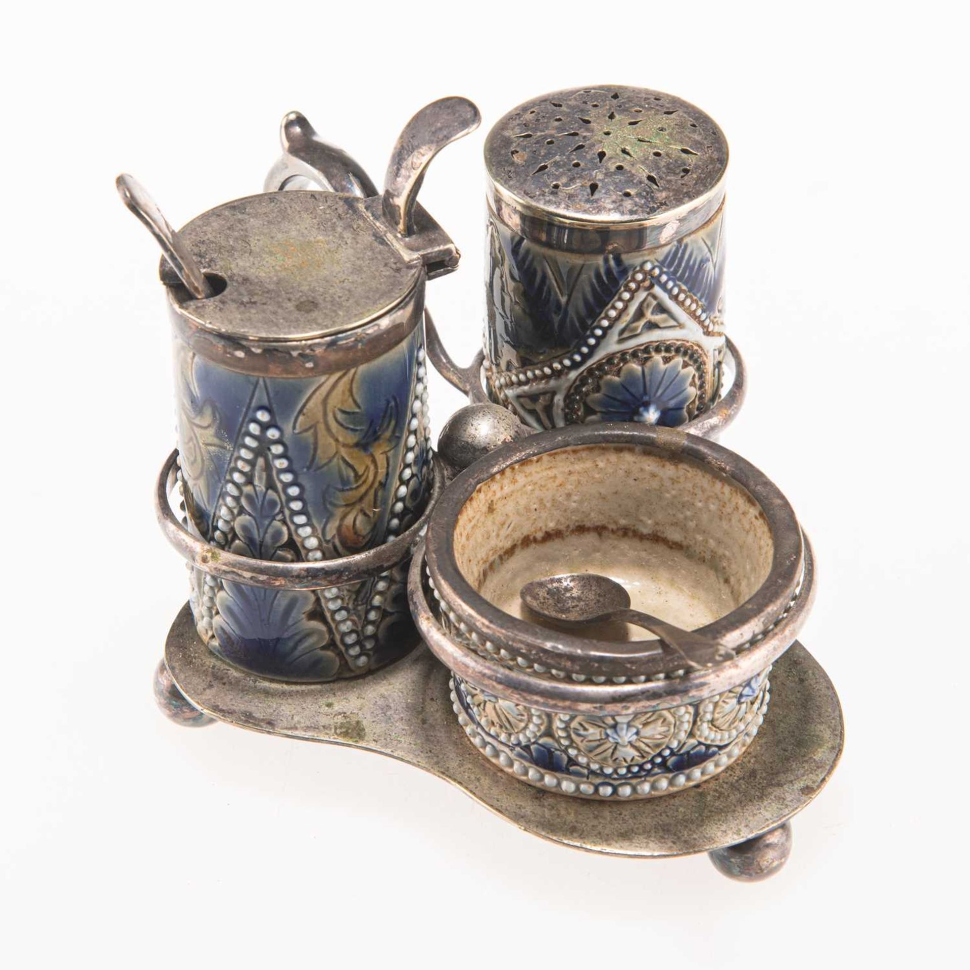 A LATE 19TH CENTURY DOULTON LAMBETH SILVER-PLATE AND STONEWARE THREE-PIECE CRUET SET ON STAND