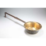 AN EARLY 18TH CENTURY BRASS AND IRON DOWN-HEARTH SKILLET, ENGLISH/WELSH