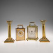 TWO CARRIAGE CLOCKS, AND A PAIR OF BRASS CORINTHIAN COLUMN CANDLESTICKS