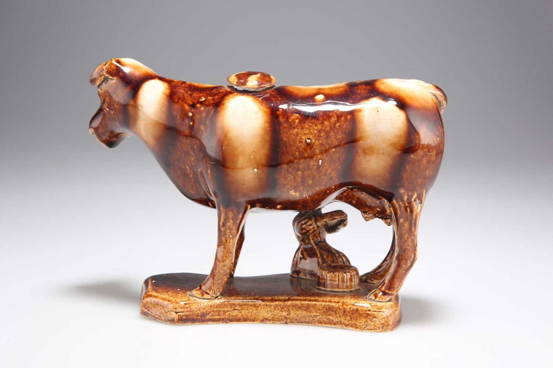 A 19TH CENTURY STAFFORDSHIRE TREACLE-GLAZED POTTERY COW CREAMER AND MILKMAID GROUP - Image 3 of 3