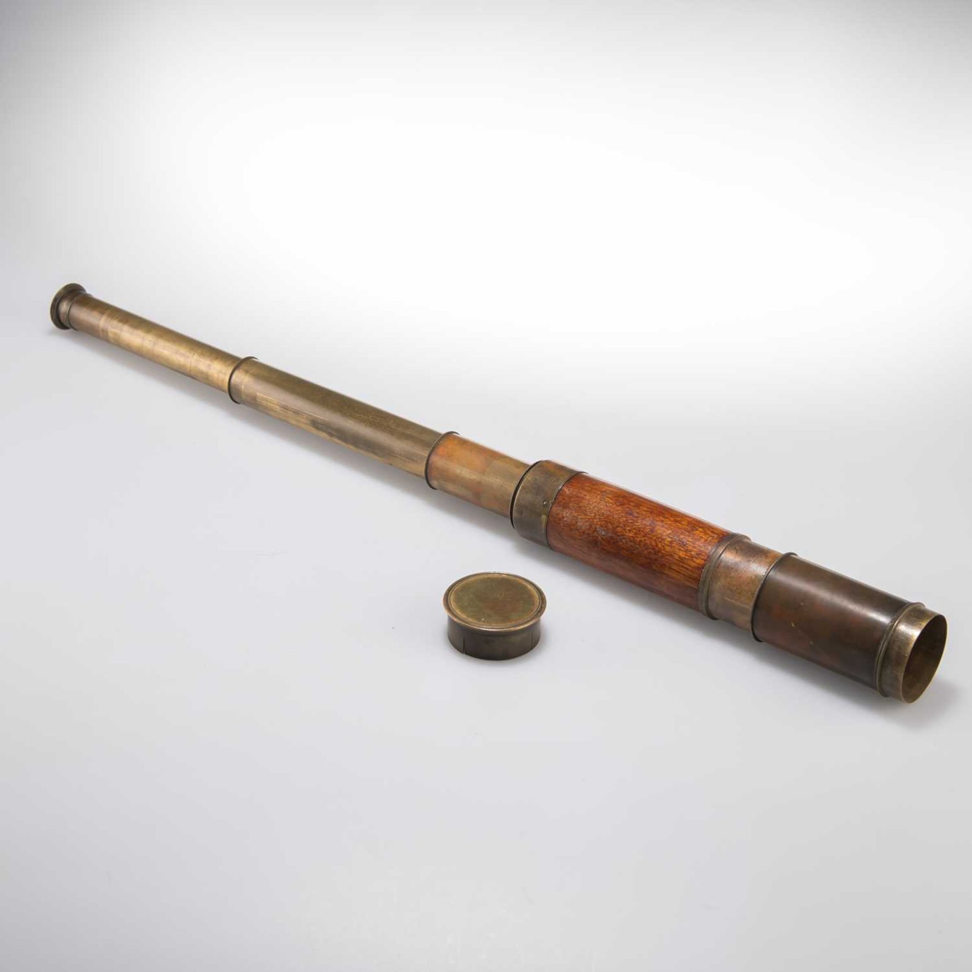 A SMALL BRASS FOUR DRAWER TELESCOPE