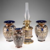 A LATE 19TH CENTURY DOULTON LAMBETH STONEWARE PEDESTAL OIL LAMP, AND THREE VASES