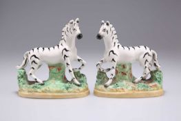 A PAIR OF 19TH CENTURY STAFFORDSHIRE POTTERY ZEBRAS