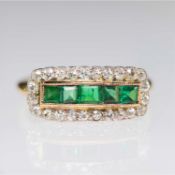 AN EMERALD AND DIAMOND HALF HOOP CLUSTER RING