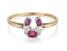 AN EARLY 20TH CENTURY RUBY AND DIAMOND HORSESHOE RING