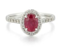 AN 18 CARAT WHITE GOLD RUBY AND DIAMOND CLUSTER RING