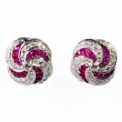 A PAIR OF 18 CARAT WHITE GOLD RUBY AND DIAMOND CLUSTER EARRINGS
