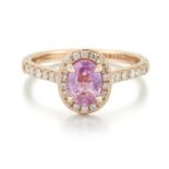 AN 18 CARAT ROSE GOLD PINK SAPPHIRE AND DIAMOND CLUSTER RING