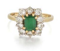 AN 18 CARAT GOLD EMERALD AND DIAMOND CLUSTER RING