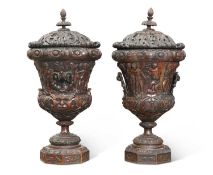 A LARGE PAIR OF CARVED WOOD URNS AND COVERS