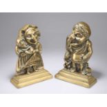 A PAIR OF VICTORIAN BRASS PUNCH AND JUDY DOOR STOPS