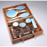 AN ART DECO SILVER AND ENAMEL-MOUNTED TRAVELLING VANITY SET