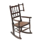 AN OAK AND RUSH-SEATED CHILD'S ROCKING CHAIR