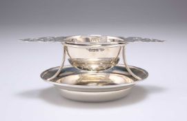 A GEORGE V SILVER TEA STRAINER ON STAND