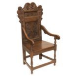 A 17TH CENTURY STYLE CARVED OAK WAINSCOT CHAIR, AND AN OAK TWO-DOOR SIDE CABINET