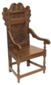 A 17TH CENTURY STYLE CARVED OAK WAINSCOT CHAIR, AND AN OAK TWO-DOOR SIDE CABINET