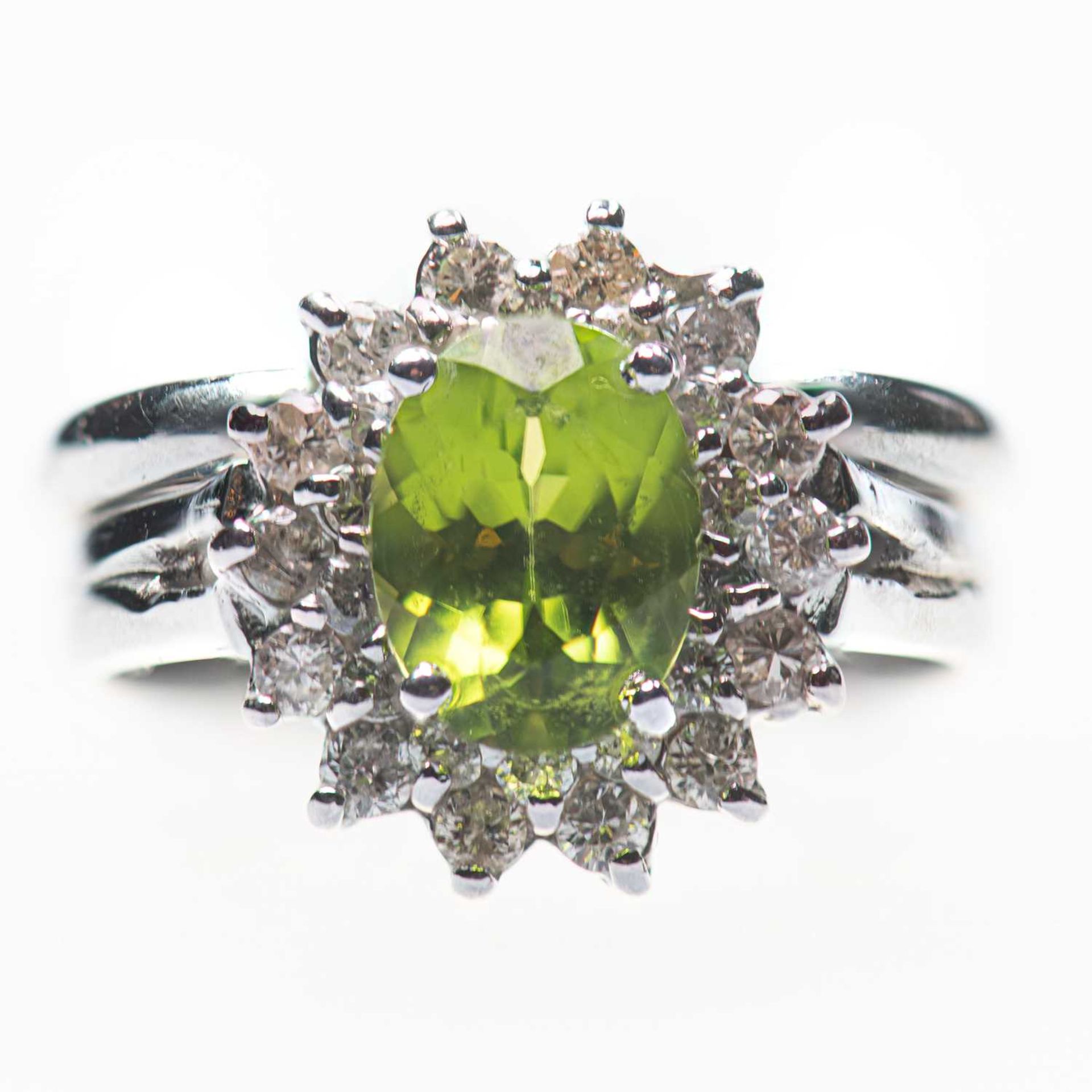 A PERIDOT AND DIAMOND CLUSTER RING