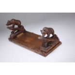 A LATE 19TH CENTURY BLACK FOREST CARVED BEAR BOOK SLIDE