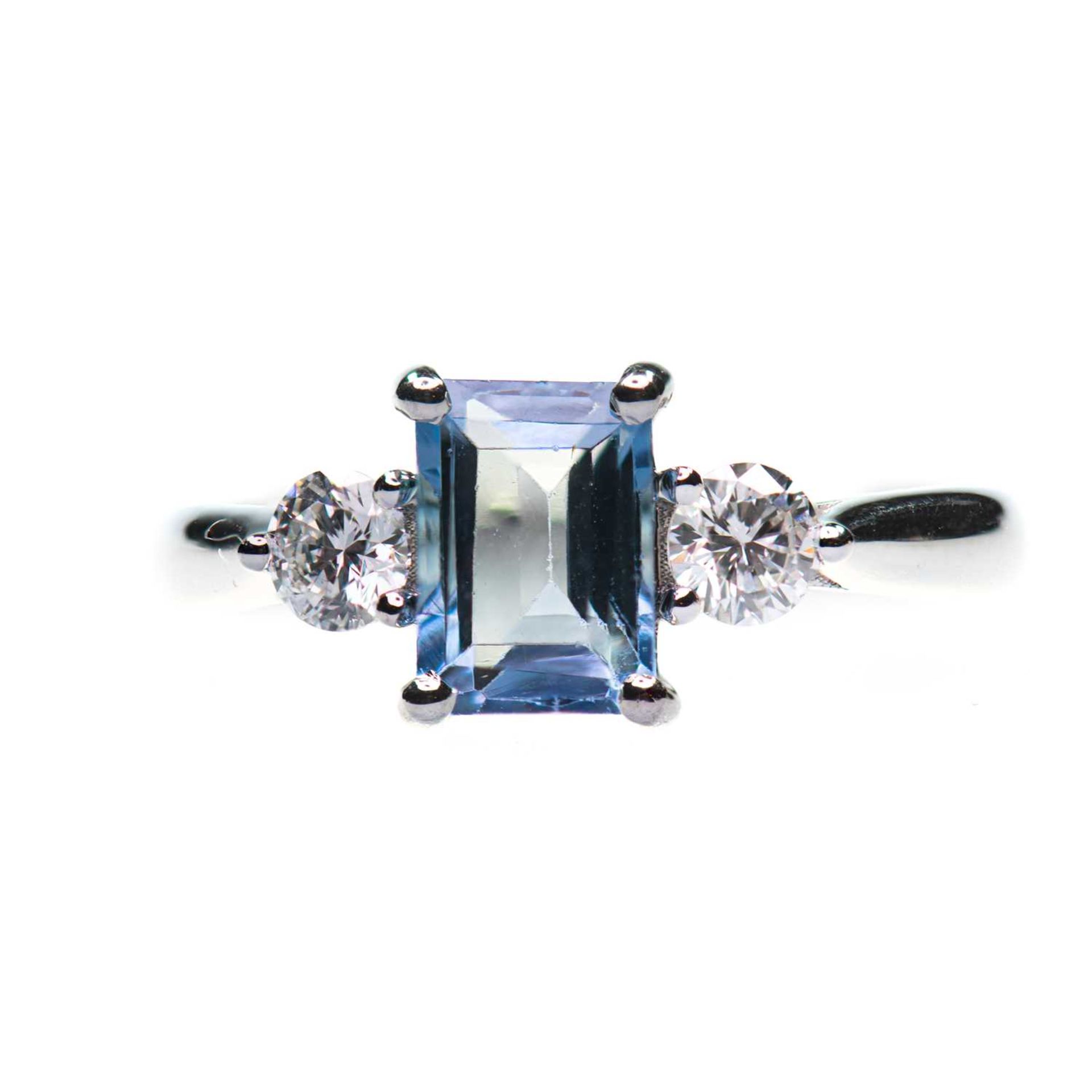 A PLATINUM AQUAMARINE AND DIAMOND THREE STONE RING