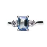 A PLATINUM AQUAMARINE AND DIAMOND THREE STONE RING