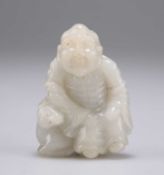 A CHINESE CARVED JADE FIGURE
