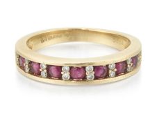AN 18 CARAT GOLD RUBY AND DIAMOND HALF HOOP RING