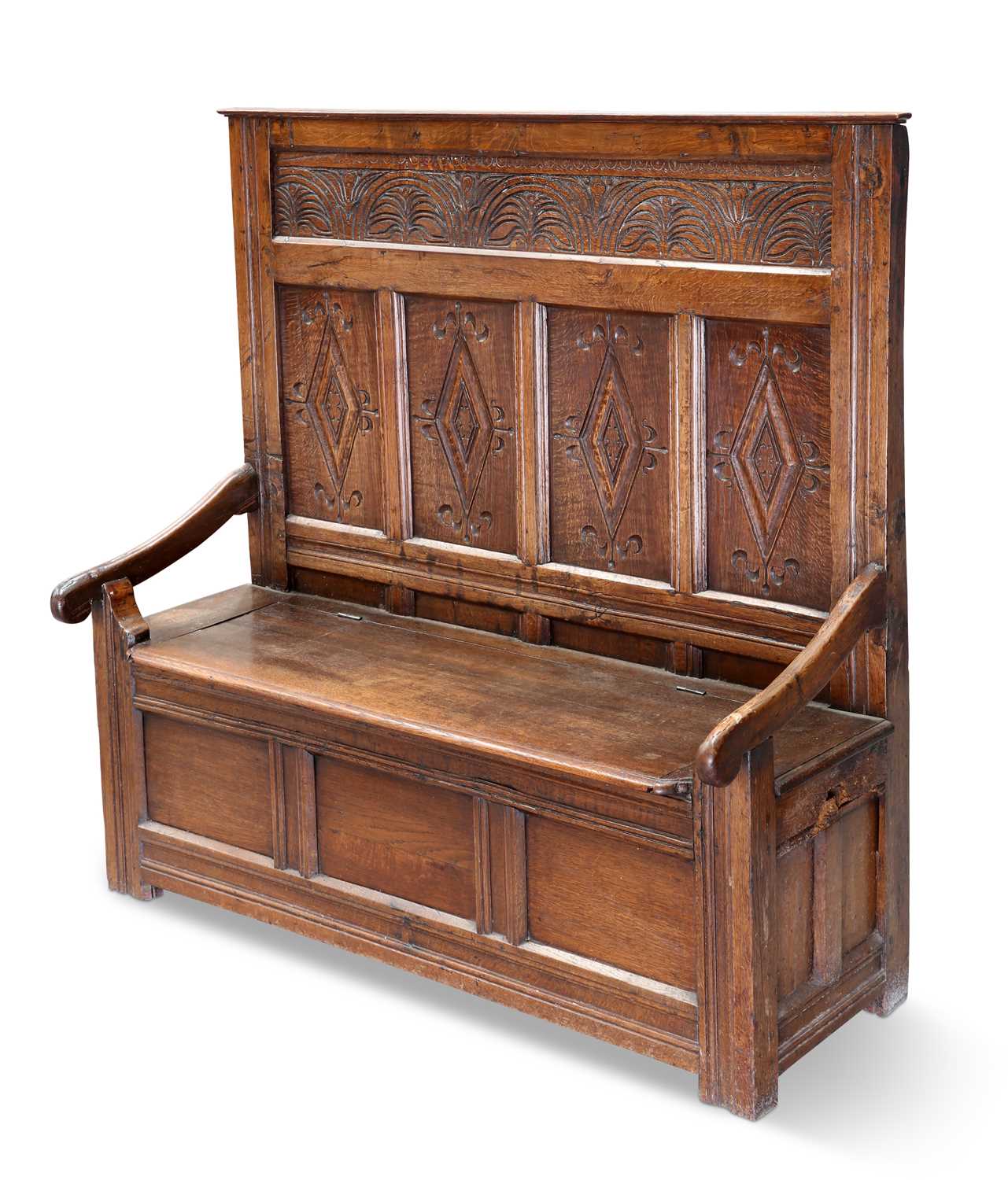 A CARVED OAK HIGH-BACK SETTLE