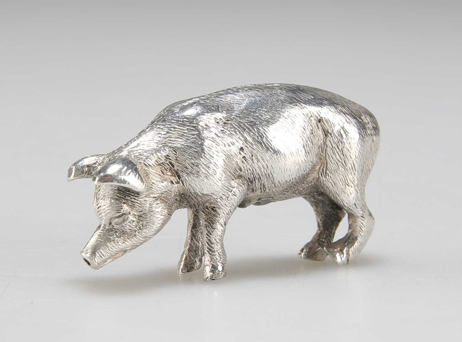 A CAST SILVER MODEL OF A PIG