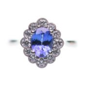 A PLATINUM SAPPHIRE AND DIAMOND CLUSTER RING