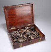 A 19TH CENTURY BRASS-MOUNTED MAHOGANY BOX CONTAINING ANTIQUE AND LATER KEYS AND PADLOCKS