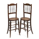 A PAIR OF 19TH CENTURY FAUX ROSEWOOD AND CANEWORK CORRECTION CHAIRS