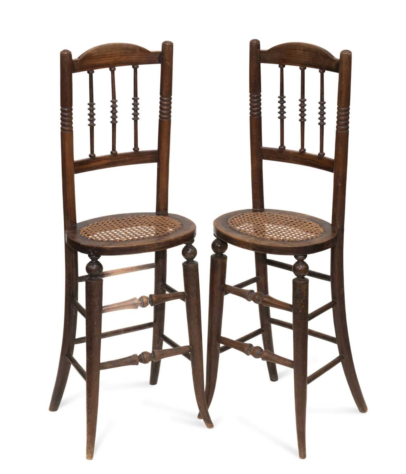 A PAIR OF 19TH CENTURY FAUX ROSEWOOD AND CANEWORK CORRECTION CHAIRS
