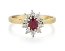 AN 18 CARAT GOLD RUBY AND DIAMOND CLUSTER RING
