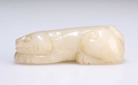 A CHINESE JADE CARVING OF A PROSTRATE LION DOG