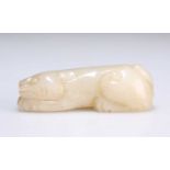 A CHINESE JADE CARVING OF A PROSTRATE LION DOG